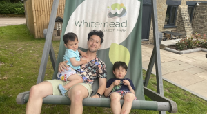 Richard and his two boys sitting on a branded Whitemead Forest Park giant deck chair